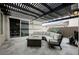 Outdoor patio with seating area, fire pit, and view into the interior dining area at 4576 Amazing View St, Las Vegas, NV 89129