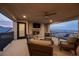 Comfortable patio features a fireplace, seating, ceiling fan, and a view of the city at 4576 Amazing View St, Las Vegas, NV 89129