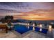 Beautiful pool and spa at sunset with lounge chairs and landscaped planters at 4576 Amazing View St, Las Vegas, NV 89129