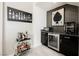 Chic wet bar boasts modern backsplash, beverage fridge, bar cart, and stylish artwork at 4576 Amazing View St, Las Vegas, NV 89129