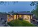 Expansive backyard view showcasing covered patio, lush lawn, and mature trees at 48 Panorama Crest Ave, Las Vegas, NV 89135