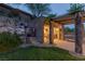Outdoor entertaining area with a pergola, kitchen, and landscaped hillside with a relaxing atmosphere at 48 Panorama Crest Ave, Las Vegas, NV 89135