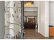 Elegant foyer with a decorative metal front door, tiled flooring, and a view into the living room at 48 Panorama Crest Ave, Las Vegas, NV 89135
