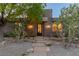 Charming home with a stone facade, desert landscaping, and a decorative iron front door at 48 Panorama Crest Ave, Las Vegas, NV 89135