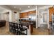 Kitchen with wood cabinets, stainless fridge, black granite island, and barstool seating at 48 Panorama Crest Ave, Las Vegas, NV 89135