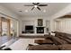 Spacious living room with fireplace, ceiling fan and leather sectional sofa at 48 Panorama Crest Ave, Las Vegas, NV 89135