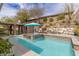 Stunning backyard pool with waterfall, built-in spa, and covered patio area, ideal for outdoor living at 48 Panorama Crest Ave, Las Vegas, NV 89135