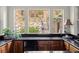 Wet bar with granite countertop, wood cabinets, wine fridge, and tiered landscape views at 48 Panorama Crest Ave, Las Vegas, NV 89135