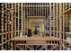 Custom wine cellar with wooden racks, ambient lighting, and ample storage space for wine bottles at 48 Panorama Crest Ave, Las Vegas, NV 89135