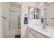 Bright bathroom featuring a walk-in shower and a large vanity mirror at 501 Starfire Pl, Las Vegas, NV 89107