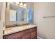 Bathroom vanity with granite countertops, wood cabinets, and a framed mirror at 501 Starfire Pl, Las Vegas, NV 89107