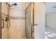 Bathroom shower with decorative tile accents and a glass door at 501 Starfire Pl, Las Vegas, NV 89107