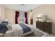 Bright bedroom features large windows and comfortable furnishings with an ensuite bathroom at 501 Starfire Pl, Las Vegas, NV 89107
