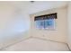 Spacious carpeted bedroom with a bright window featuring decorative curtains at 501 Starfire Pl, Las Vegas, NV 89107