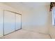 Bedroom with carpeted floors, sliding door closet, and a bright window at 501 Starfire Pl, Las Vegas, NV 89107