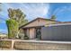 Inviting home entrance with mature trees and a private, fenced yard at 501 Starfire Pl, Las Vegas, NV 89107