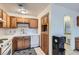 Efficient kitchen features white appliances, tile countertops, and oak cabinetry at 501 Starfire Pl, Las Vegas, NV 89107