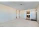 Bright living room featuring neutral paint, carpet, and entry to dining area at 501 Starfire Pl, Las Vegas, NV 89107