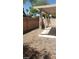 Backyard with a covered patio space featuring a rock garden and privacy wall at 5213 Castle Butte Ct, North Las Vegas, NV 89031