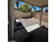 Backyard featuring a covered patio, gravel landscaping, and secure fencing at 5213 Castle Butte Ct, North Las Vegas, NV 89031