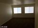 A carpeted bedroom features dual windows for ample natural light at 5213 Castle Butte Ct, North Las Vegas, NV 89031