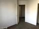 A carpeted bedroom features white walls and an open closet at 5213 Castle Butte Ct, North Las Vegas, NV 89031