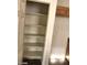 Linen closet features multiple shelves for optimized storage and organization at 5213 Castle Butte Ct, North Las Vegas, NV 89031