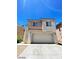Two-story home featuring a spacious two-car garage and stucco exterior at 5213 Castle Butte Ct, North Las Vegas, NV 89031