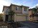 Two-story home featuring a spacious two-car garage and neutral stucco at 5213 Castle Butte Ct, North Las Vegas, NV 89031