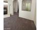 Inviting living room with tile fireplace, plush carpeting, and open archway at 5213 Castle Butte Ct, North Las Vegas, NV 89031