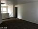 Spacious living room with carpet floors and natural light from the windows at 5213 Castle Butte Ct, North Las Vegas, NV 89031