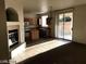 Living room showcasing an electric fireplace and seamless flow into the kitchen at 5213 Castle Butte Ct, North Las Vegas, NV 89031