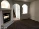 Cozy living room with archways, stairs, and modern fireplace at 5213 Castle Butte Ct, North Las Vegas, NV 89031