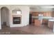 Living room showcasing an electric fireplace and seamless flow into the kitchen at 5213 Castle Butte Ct, North Las Vegas, NV 89031