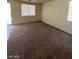 Living room area featuring carpet, neutral walls, and natural light at 5213 Castle Butte Ct, North Las Vegas, NV 89031