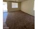 Expansive living space with carpet, sliding glass door, and natural light at 5213 Castle Butte Ct, North Las Vegas, NV 89031