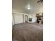 Open-concept living space with tile fireplace, archways, kitchen view, and neutral tones at 5213 Castle Butte Ct, North Las Vegas, NV 89031