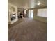 Bright living space featuring a fireplace, adjacent kitchen, and sliding door access at 5213 Castle Butte Ct, North Las Vegas, NV 89031
