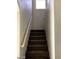 Carpeted stairway featuring a handrail and natural lighting at 5213 Castle Butte Ct, North Las Vegas, NV 89031