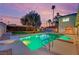 The backyard features a refreshing pool and spa, perfect for outdoor living, with lush greenery at 5239 Somerset Dr, Las Vegas, NV 89120