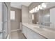 This bathroom features double sinks and a shower over tub with glass doors at 5239 Somerset Dr, Las Vegas, NV 89120