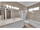 This bathroom features a shower over tub, neutral tile, and bright lighting at 5239 Somerset Dr, Las Vegas, NV 89120