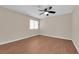 This bedroom features wood floors, a ceiling fan, and a window for natural light at 5239 Somerset Dr, Las Vegas, NV 89120