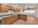 Kitchen featuring wood cabinets, granite counters, and access to living room at 5239 Somerset Dr, Las Vegas, NV 89120