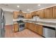 Kitchen featuring wood cabinets, granite counters, and stainless steel appliances at 5239 Somerset Dr, Las Vegas, NV 89120