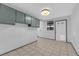 This laundry room features tile floors, storage cabinets, and a back door to the yard at 5239 Somerset Dr, Las Vegas, NV 89120