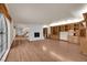 Open living room featuring hardwood floors, built-in shelving and brick fireplace at 5239 Somerset Dr, Las Vegas, NV 89120