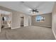 Large carpeted main bedroom with a ceiling fan, closet, ensuite bathroom and large window at 5239 Somerset Dr, Las Vegas, NV 89120