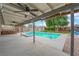 Backyard view featuring a refreshing swimming pool, hot tub, covered patio, and desert landscaping at 5239 Somerset Dr, Las Vegas, NV 89120
