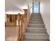 Carpeted staircase with hardwood banister and a window letting in natural light at 5239 Somerset Dr, Las Vegas, NV 89120